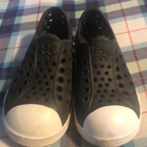 Black and white plastic slip on shoe. Size 9-10 toddler. Like new